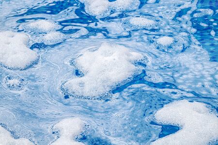 Soap foam on the water in the pool as an abstract background. Blurの写真素材