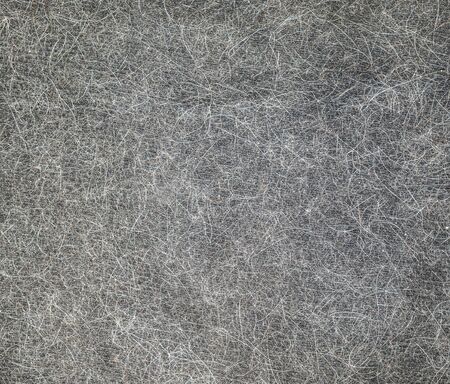 Cat hair on black clothes as a background for designの写真素材