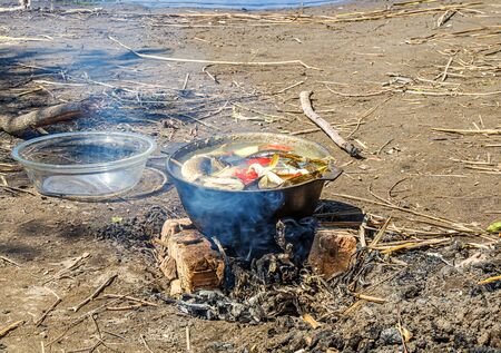 Cooking fish soup fish soup in the fire in natureの写真素材