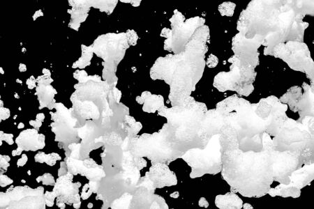 Soap foam on a black background as a background for design. The atmosphere of the holiday and summer outdoor recreation.の写真素材