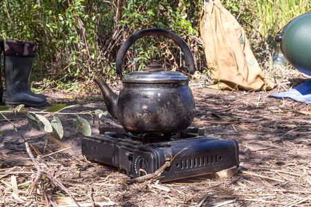 Kettle on the stove in natureの写真素材