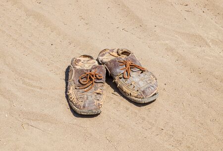Old ragged sandals for menの写真素材
