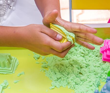 Children build kinetic sand figuresの写真素材
