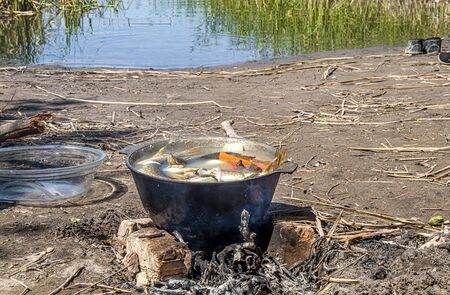 Cooking fish soup fish soup in the fire in natureの写真素材