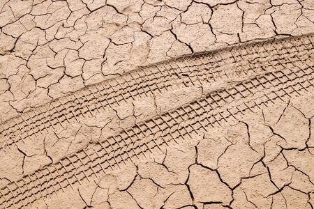 Traces of cars in the mud close-up as a background for design