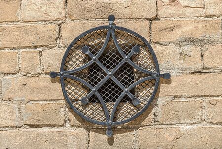 Brickwork and window bars in an old buildingの写真素材