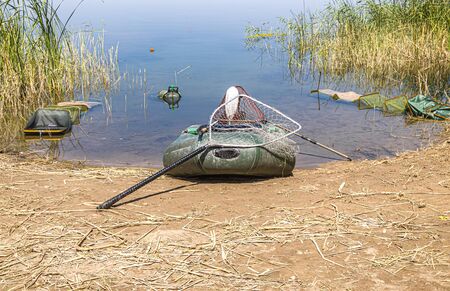 Inflatable fishing boat on the shoreの写真素材