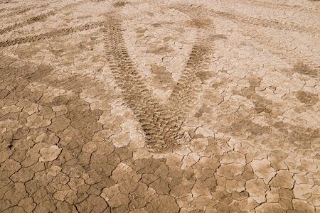 Traces of cars in the mud close-up as a background for designの写真素材
