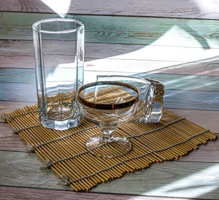 Empty glassware lit by the sun.の写真素材
