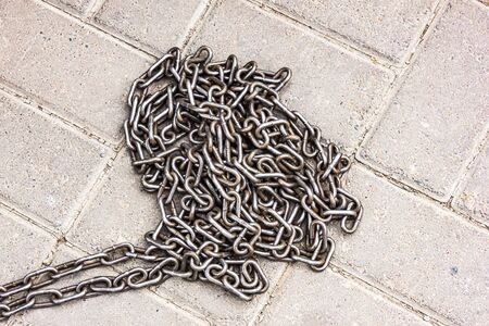 Iron chain on concrete floorの写真素材