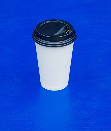 Plastic cup with water on a blue backgroundの写真素材