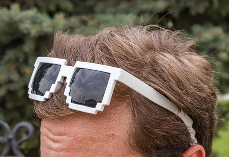 Sunglasses on the head of a young man close-upの写真素材