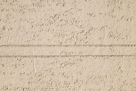 Wall plastered with putty bark beetle painted as background for designの写真素材