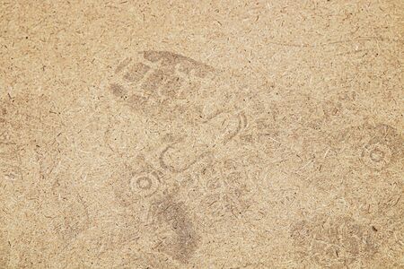 Fibreboard with footprints as backgroundの写真素材