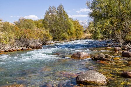 Stones in a mountain river landscape. Water in a stormy mountain riverの写真素材