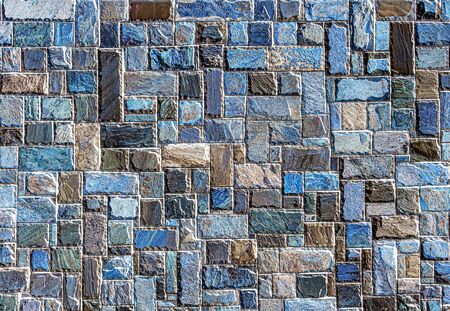 Wall of colored artificial stone as a background.