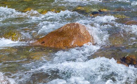 Stones in a mountain river landscape. Water in a stormy mountain riverの写真素材