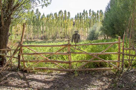 Gate from poles in a rural gardenの写真素材