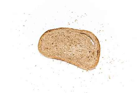 Sliced rye bread with crumbs on a white background. Selective focus.