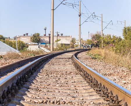 Young people teenagers walk on the railroad tracksの写真素材