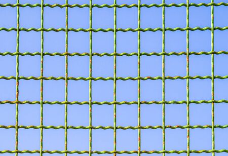 Metal mesh against the blue sky.
