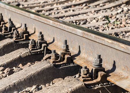 Fastenings of metal railway rails close-upの写真素材