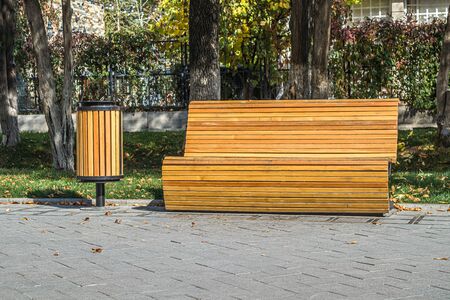 Wooden bench and urn on the boulevardの写真素材