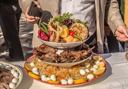 Uzbek pilaf in a dish. Beautiful serving and serving dishes.の写真素材