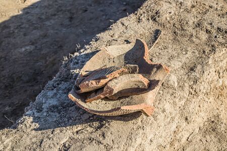 Shards of clay pottery at an archaeological site.の写真素材