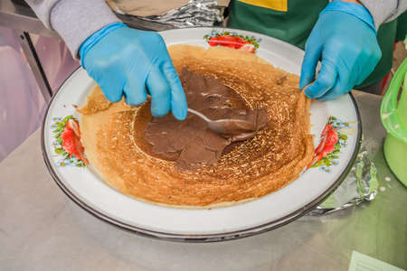 Making Russian pancakes with filling on an industrial scale in a cafe.の写真素材