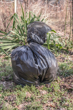 Black garbage bag in the gardenの写真素材