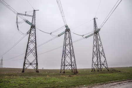 Metal electrical cable poles used in the field during rainy weather.の写真素材