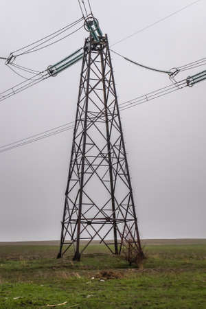 Metal electrical cable poles used in the field during rainy weather.の写真素材