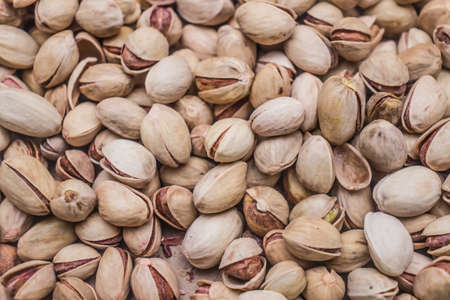 Lots of pistachio nuts as a background. top view.の写真素材