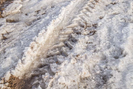 Wheel tracks on melting snow in springの写真素材
