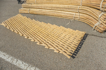 The wooden details of the Asian yurt lie on the pavement. Assembling the yurt.の写真素材