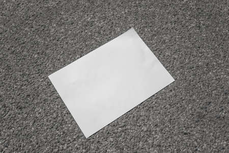 White sheet of paper on the pavement. Free space for text.の写真素材