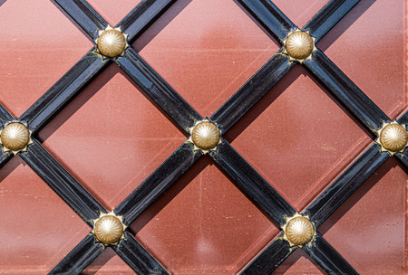 Forged and painted metal gate elements close-up as a background.の写真素材