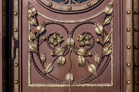 Forged and painted metal gate elements close-up as a background.の写真素材