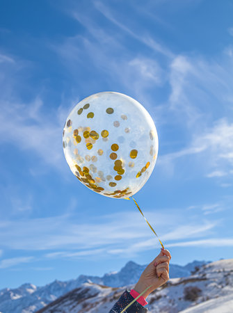 Balloon in the hand of a girl in nature in winter.の写真素材