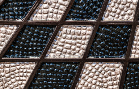 Forged and painted metal gate elements close-up as a background.