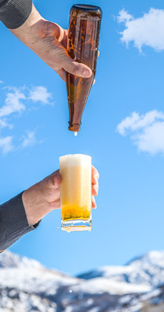 Glass cup with cold beer against the sky.の写真素材