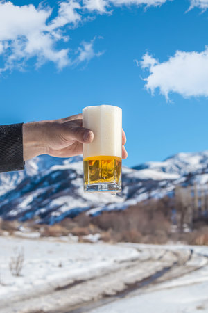 Glass cup with cold beer against the sky.の写真素材