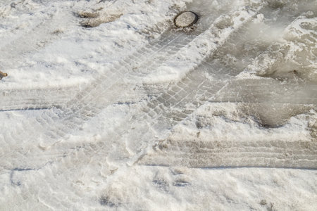 Melted snow on the road in spring.の写真素材