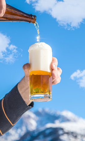 Glass cup with cold beer against the sky.の写真素材