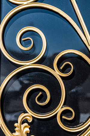 Forged and painted metal gate elements close-up as a background.の写真素材