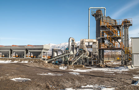 Industrial equipment on a small asphalt plant against the sky.の写真素材