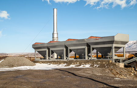 Industrial equipment on a small asphalt plant against the sky.の写真素材