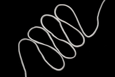 White rope on a black background.の写真素材