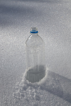 Plastic bottle in the snow in nature.の写真素材